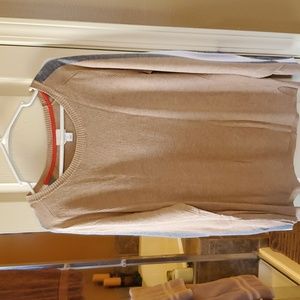 Tan sweater with white and gray stripes on sleeves.